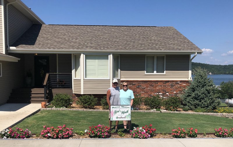 Courtesy photo The August Beaver Shores POA Yard of the Month went to Sean and Angie Spicer at 8090 N. Lakeshore Drive in Rogers. Sean does landscaping on the side and has done a transformation to this yard that was once full of Yuca plants. Now there are pink azaleas across the front, vincas, elephant ears, hosta plants, verbena, impatiens, a Japanese maple tree and Colorado blue spruce. Sponsor Bradford Yard Living + Landscaping provided a $25 gift card to the couple.