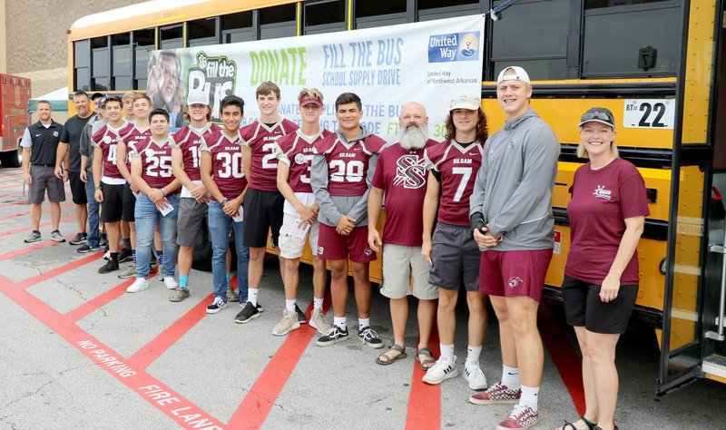 Photo submitted The Siloam Springs football team recently volunteered for the Fill the Bus event at Walmart on Aug. 3.