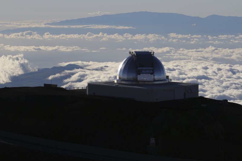 FILE - In this July 14, 2019, file photo, a telescope at the summit of Mauna Kea, Hawaii's tallest mountain is viewed. Astronomers across 11 observatories on Hawaii&#x2019;s tallest mountain have cancelled more than 2,000 hours of telescope viewing over the past four weeks because a protest blocked a road to the summit. Astronomers said Friday, Aug. 9, 2019, they will attempt to resume observations but in some cases won&#x2019;t be able to make up the missed research. (AP Photo/Caleb Jones, File)