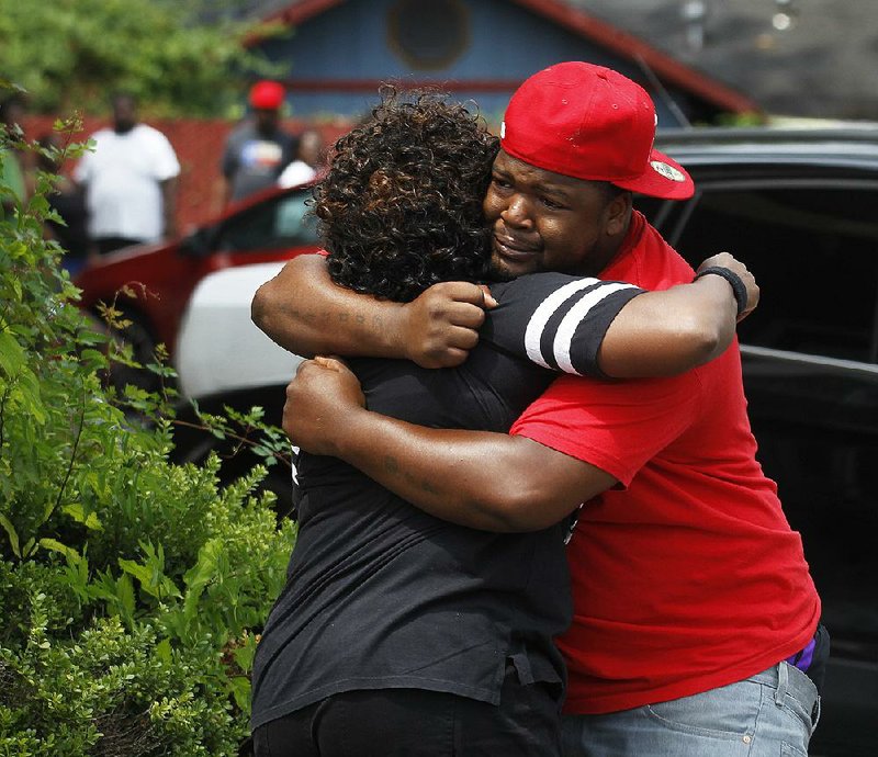 Family members react after arriving at the Terra Vista apartments after a man was shot on Sunday in Little Rock. Little Rock police have not released the name of the shooting victim. 