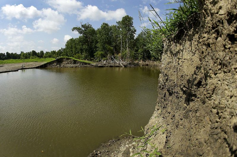 A 20-foot-deep pool of water is seen Tuesday near Saline City, Mo. The water fills an area where a levee failed as the Missouri River flooded earlier this year. 