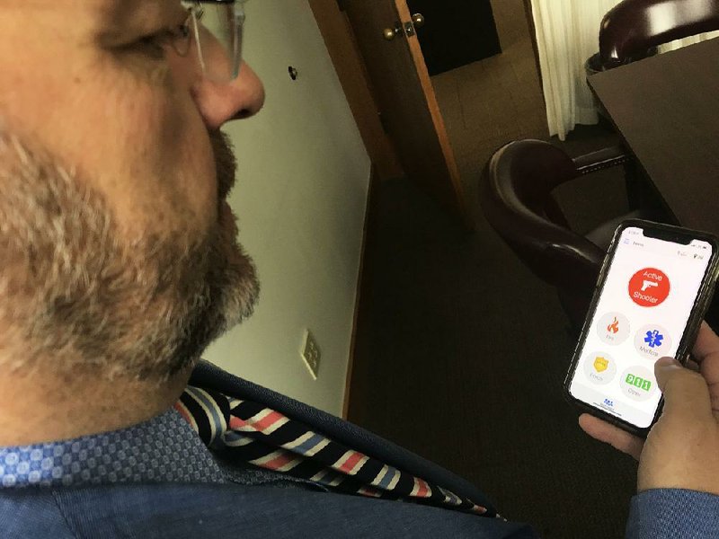 Doug Bradberry, Arkansas’ school safety coordinator, demonstrates the functionality of the Rave Panic Button mobile app in use in all 239 school districts in the state. Arkansas was the first state to adopt the mobile app in 2015. 