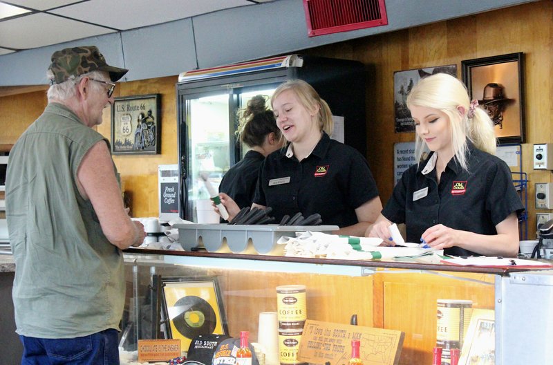 Members of the Old South's wait staff serve a local customer Aug. 1. (Special to the Democrat-Gazette/ELI CRANOR)