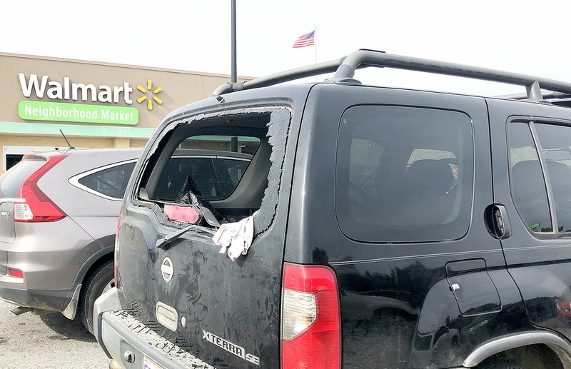 NWA Democrat-Gazette/ANNETTE BEARD A 4-month-old boy was rescued from this vehicle in the parking lot at the Walmart Neighborhood Market in Pea Ridge Sunday afternoon. Nathaniel Holt broke the back glass with a brick, unlocked the vehicle and his wife, Michelle, got the child out.