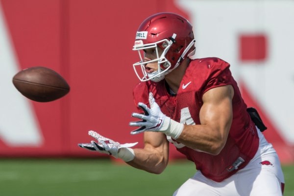 Chase Harrell, Arkansas tight end, catches a pass Wednesday, Aug. 7, 2019, at the Arkansas practice fields in Fayetteville.