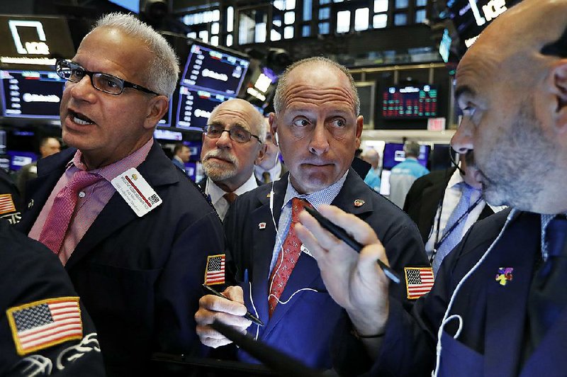 Traders work Monday on the floor of the New York Stock Exchange. After the day’s losses, the major stock indexes are down more than 3% this month. 