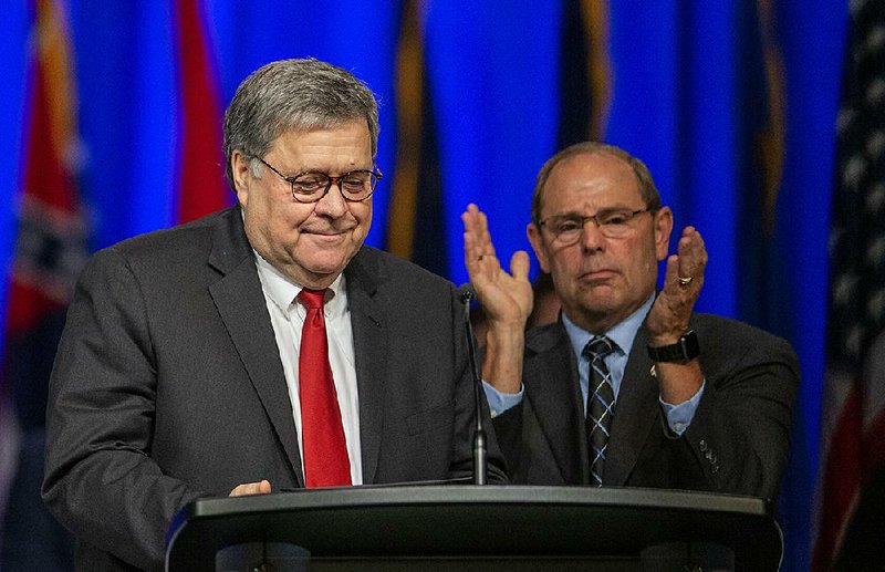 Attorney General William Barr (left), shown with Fraternal Order of Police President Chuck Canter- bury at an event in New Orleans, said Monday that the death of Jeffrey Epstein wouldn’t stop the investigation of those who might have helped him traffic girls for sex. 