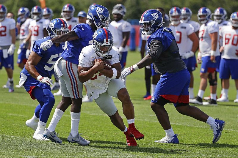 New York Giants running back Saquon Barkley (center) rushed for 1,307 yards and 11 touchdowns on 261 carries in 2018.