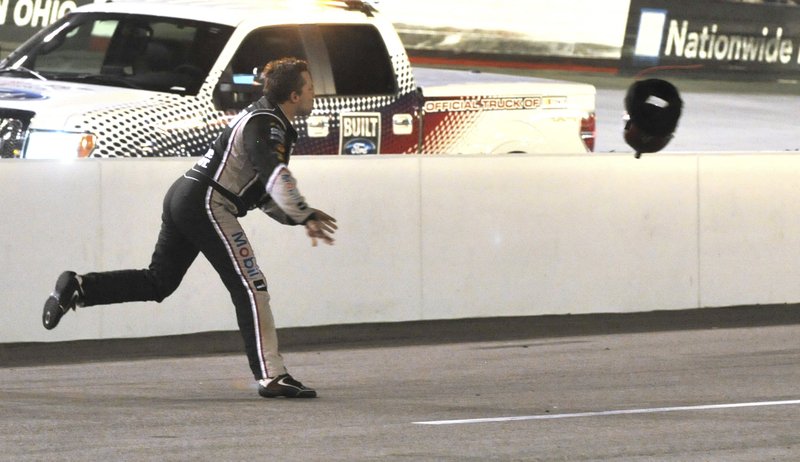 FILE - In this Aug. 25, 2012, file photo, driver Tony Stewart throws his helmet at Matt Kenseth's car after the two collided during a NASCAR Sprint Cup Series auto race at Bristol Motor Speedway in Bristol, Tenn. The track forever marketed itself as a raging tempest for drivers to lose their cool and explode in aggressive anger. Jeff Gordon once shoved Matt Kenseth, Tony Stewart threw a helmet, middle fingers are the common form of communication, and tempers are typically teetering right at the boiling point. (Earl Neikirk/Bristol Herald Courier via AP, File)