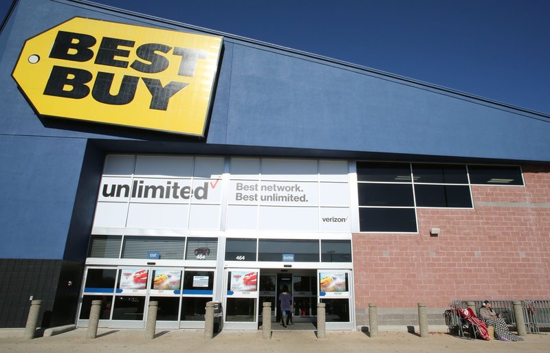 A Black Friday shopper sits in front of the Best Buy retail store in Fayetteville.