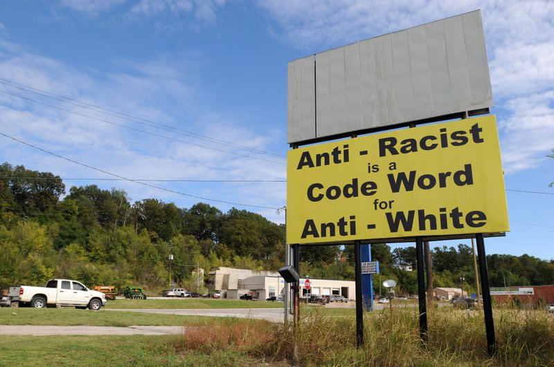 In this 2013 photo, motorists drive past a billboard near the intersection of Arkmo Road and Vine Road in Harrison. When the billboard went up, the Harrison Community Task Force on Race Relations responded with a "Love Your Neighbor" billboard campaign.