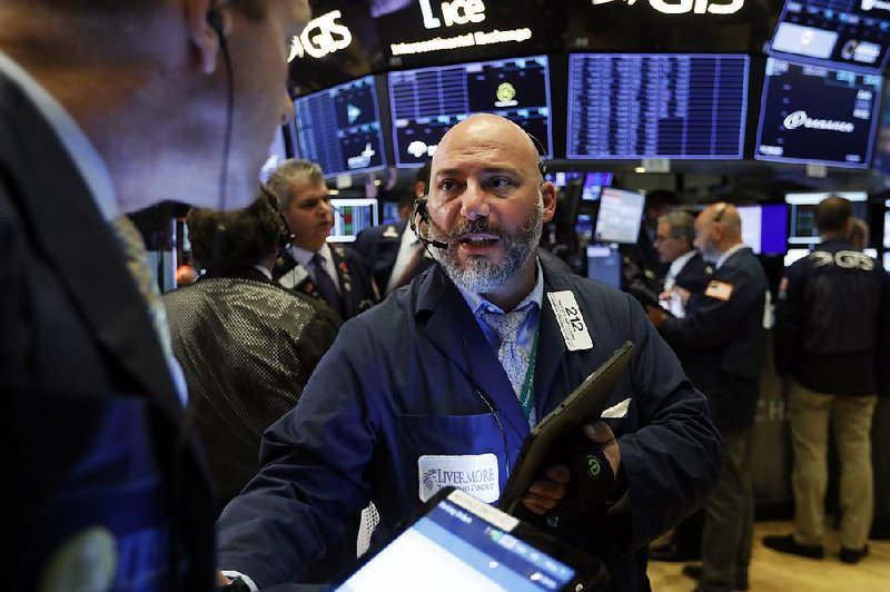 Trader Vincent Napolitano works Tuesday at the New York Stock Exchange as stocks rebounded on the tariffs decision. 