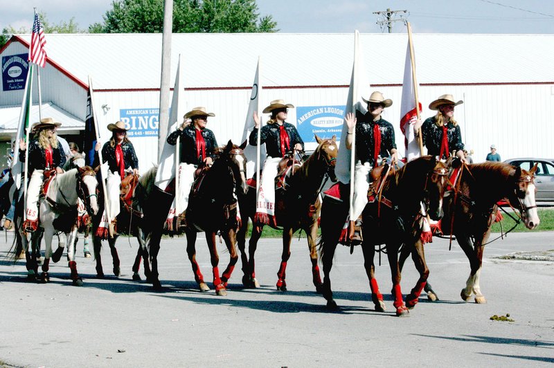 MARK HUMPHREY ENTERPRISE-LEADER/The Arkansas Fillies, a junior precision drill team formed by members of the Lincoln Riding Club, paraded Saturday as part of the 66th annual Lincoln Rodeo festivities.
