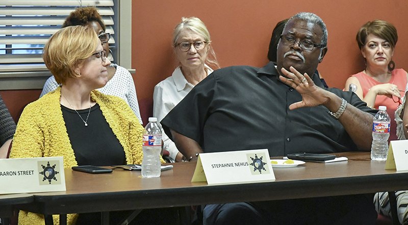 The Sentinel-Record/Grace Brown CHURCH AND SCHOOL: Stephanie Nehus, left, superintendent of the Hot Springs School District, listens last week as the Rev. Donald Crossley, pastor of St. Mark Missionary Baptist Church, talks during a roundtable discussion at the Hot Springs Police Department about the increase in violence in Hot Springs.