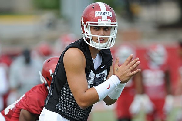 Arkansas quarterback Nick Starkel waits for the snap Friday, Aug. 2, 2019, during practice at the university practice field in Fayetteville.