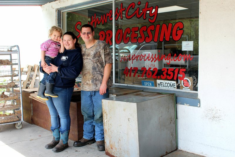 MEGAN DAVIS/MCDONALD COUNTY PRESS Jeremy and Sara Buchite are pictured with their 4-year-old daughter Izabella in front of their business, Southwest City Processing. The facility has been in Jeremy's family for 40 years, and the couple took over operations at the beginning of August.