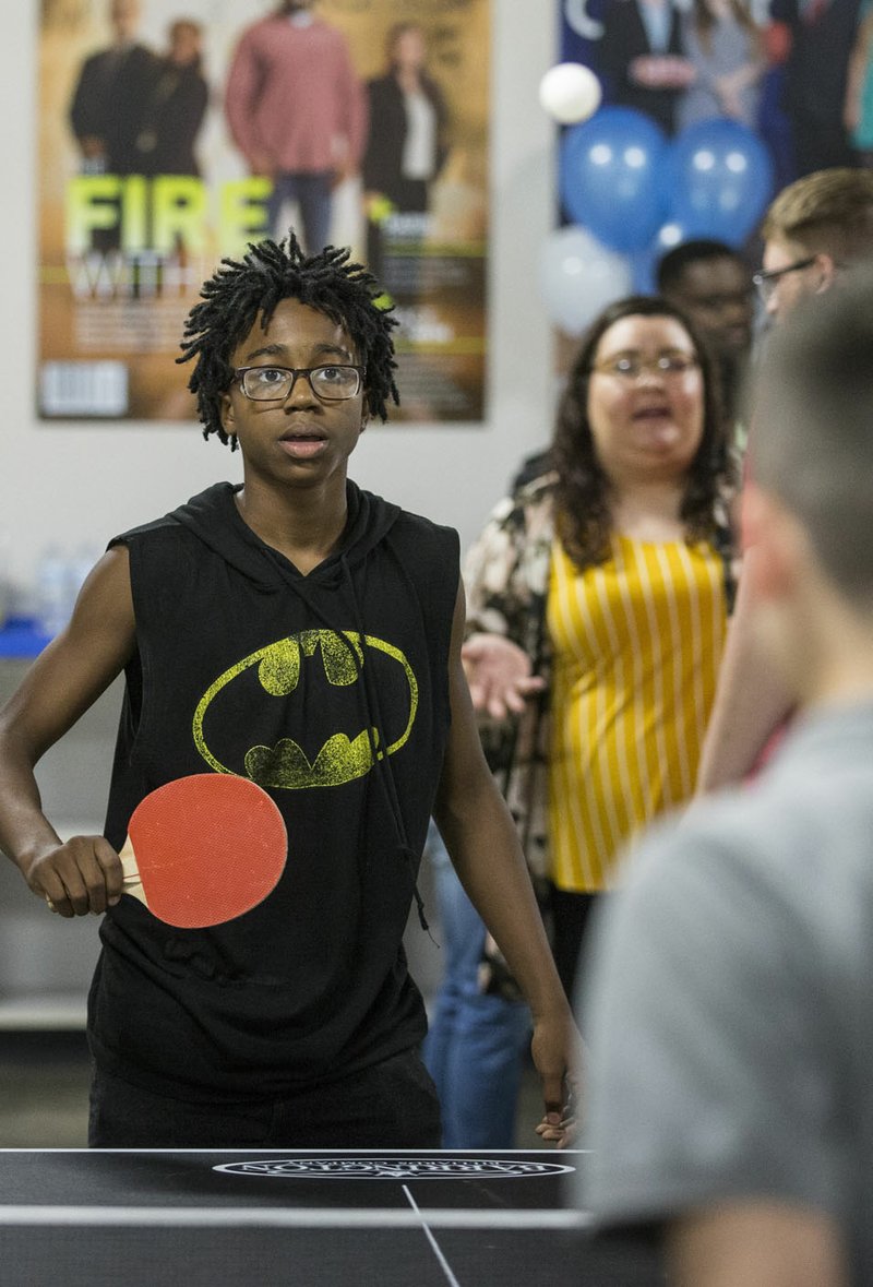 FILE PHOTO/BEN GOFF @NWABENGOFF Karmeneo Stephens (facing) plays table tennis with Eric Martinez, both teens who attend the club, June 6, 2019, during a grand opening for the new Teen Center across the street from the Boys &amp; Girls Club in Rogers. Sip &amp; Savor on Aug. 22 will help support the nonprofit organization.