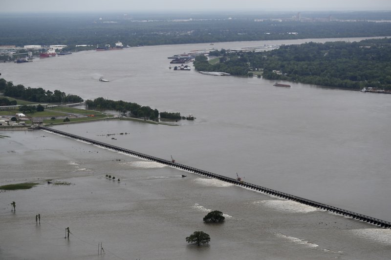 The Associated Press DIVERTING: Workers open bays of the Bonnet Carre Spillway on May 10 to divert rising water from the Mississippi River to Lake Pontchartrain, upriver from New Orleans, in Norco, La.