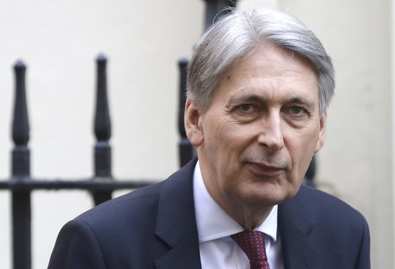  In this file photo dated Wednesday, April 10, 2019, Britain's Chancellor of the Exchequer Philip Hammond in Downing Street in London. Hammond, who stepped down as Treasury chief before Boris Johnson became prime minister, has broken his silence on the new administration in an article published in The Times of London Wednesday Aug. 14, 2019, saying Britain is being pushed towards a no-deal Brexit by "unelected people". (AP Photo/Kirsty Wigglesworth, FILE)