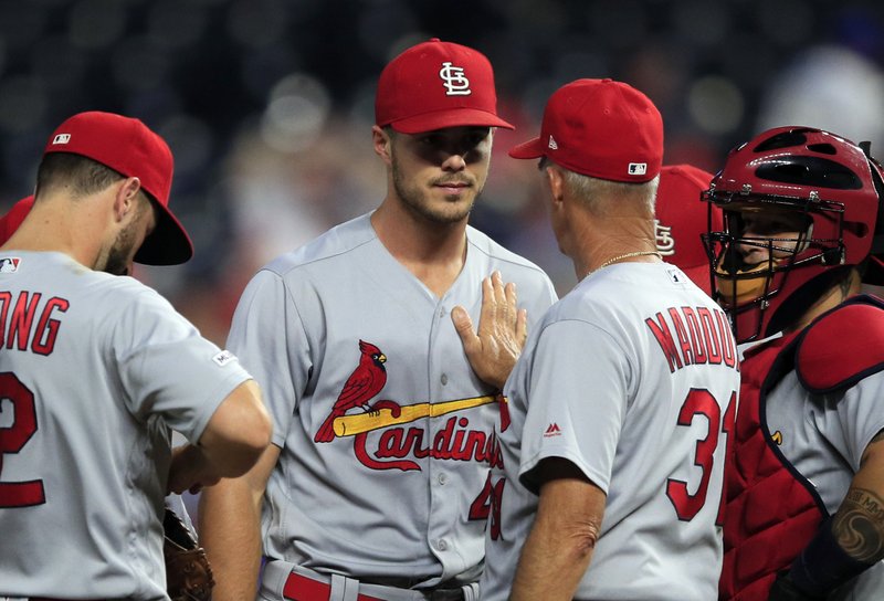 St. Louis Cardinals starting pitcher Dakota Hudson, facing camera, has a talk with pitching coach Mike Maddux (31) during the sixth inning of the team's baseball game against the Kansas City Royals at Kauffman Stadium in Kansas City, Mo., Wednesday, Aug. 14, 2019. (AP Photo/Orlin Wagner)