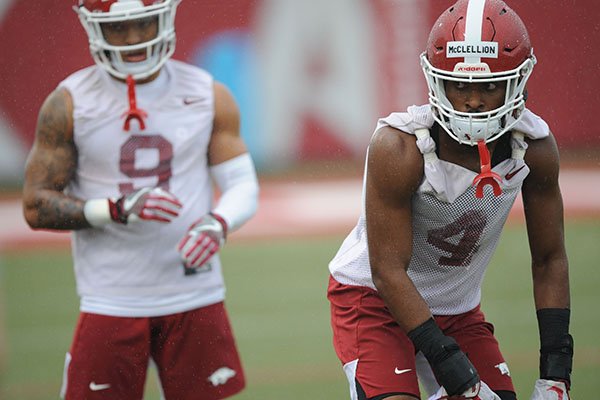 Arkansas defensive backs Jarques McClellion (4) and Greg Brooks Jr. (9) line up for a drill Saturday, Aug. 3, 2019, during practice at the university practice field in Fayetteville. 