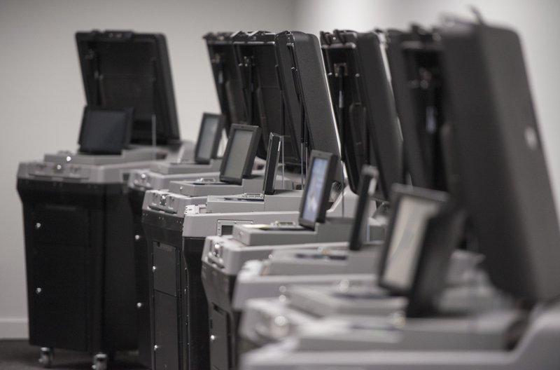 FILE PHOTO A row of DS200 precinct scanner and tabulator machines sit out for testing Tuesday, April 24, 2018, at the Benton County Election Commission office in Rogers.