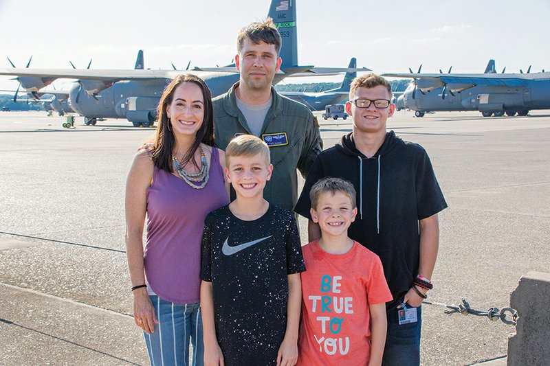 Amy and Pete Hughes of Cabot stand with their family on the Jacksonville Air Force Base, where Pete is a reservist. The couple adopted Kylar, 17, through a nonprofit organization called Project Zero. Also pictured are the couple’s two biological children, Noah, 10, front left, and Owen, 8. Amy owns The Humble Thread in Cabot.