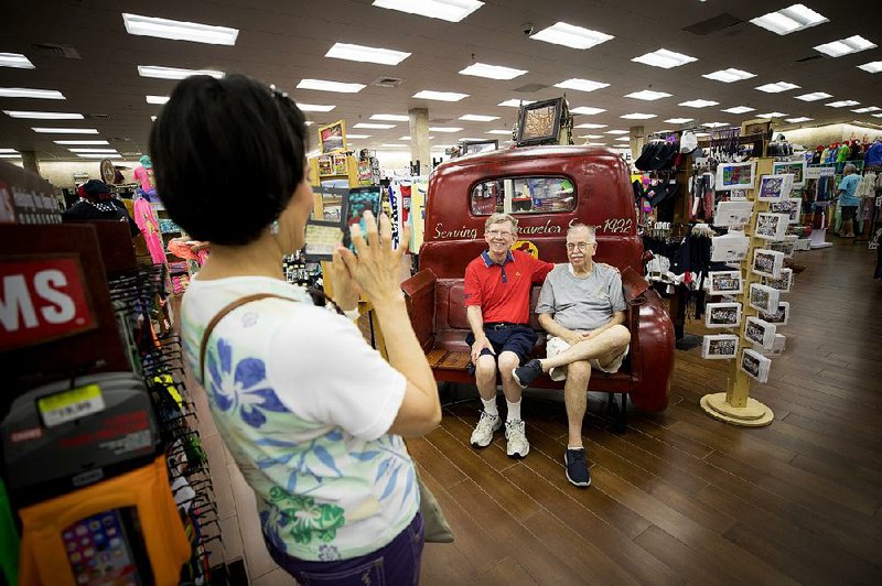 Luz Kennedy photographs her husband, Gary Kennedy (right) and friend Larry Siemens inside the Buc-ee’s in Terrell. 