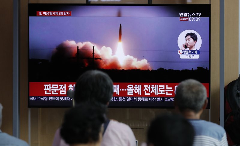 People watch a TV news program reporting about North Korea's firing projectiles with a file image at the Seoul Railway Station in Seoul, South Korea, Friday, Aug. 16, 2019.  (AP Photo/Lee Jin-man)