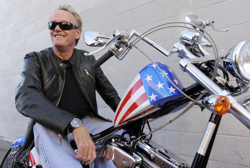 In this Friday, Oct. 23, 2009 file photo, Peter Fonda, poses atop a Harley-Davidson motorcycle in Glendale, Calif. 