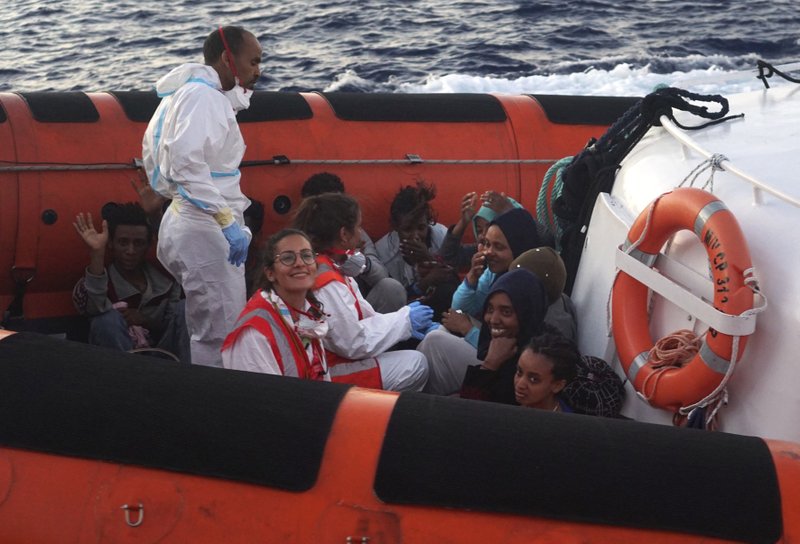 Migrants are evacuated by Italian Coast guards from the Open Arms Spanish humanitarian boat off the coast of the Sicilian island of Lampedusa, southern Italy, Thursday, Aug.15, 2019.  (AP Photo/Francisco Gentico)