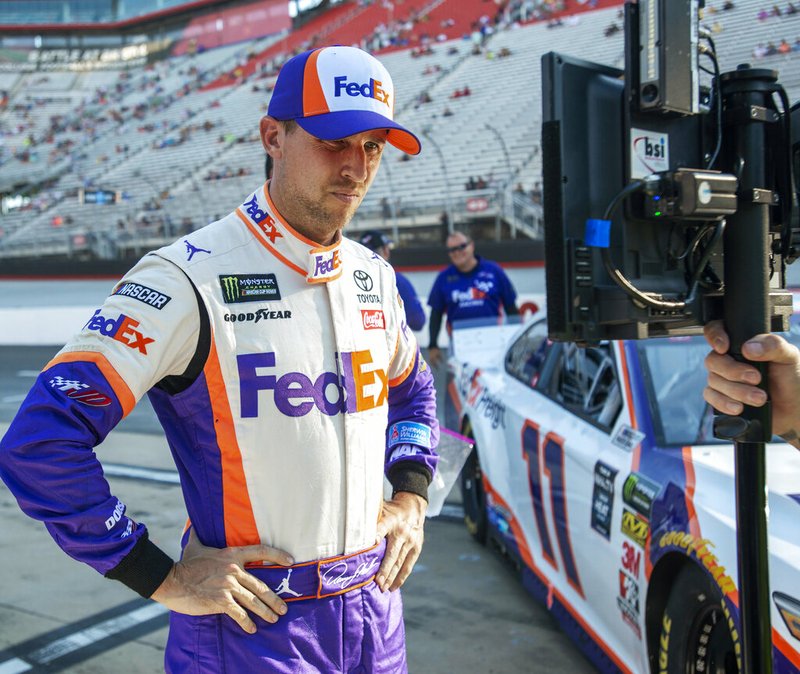 The Associated Press
WATCHING AND WAITING:
Denny Hamlin watches a television monitor Friday as the last car qualifies for the NASCAR Cup Series auto race at Bristol Motor Speedway in Bristol, Tenn. Hamlin won the pole for Saturday night's race. 