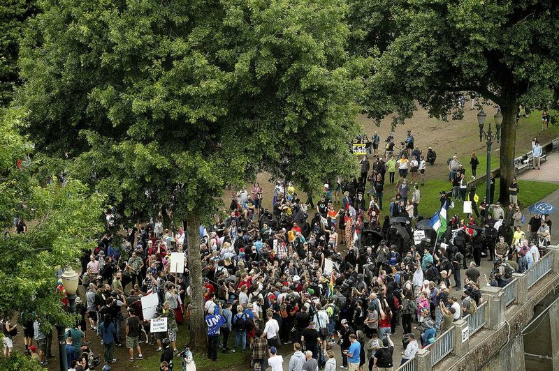 People gather at Tom McCall Waterfront Park in Portland, Ore., the site of Saturday’s dueling demonstrations. 