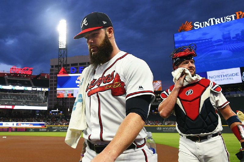 Atlanta pitcher Dallas Keuchel (left) kept himself in shape before signing with the Braves, which has led to success on the field that hasn’t translated to many victories.