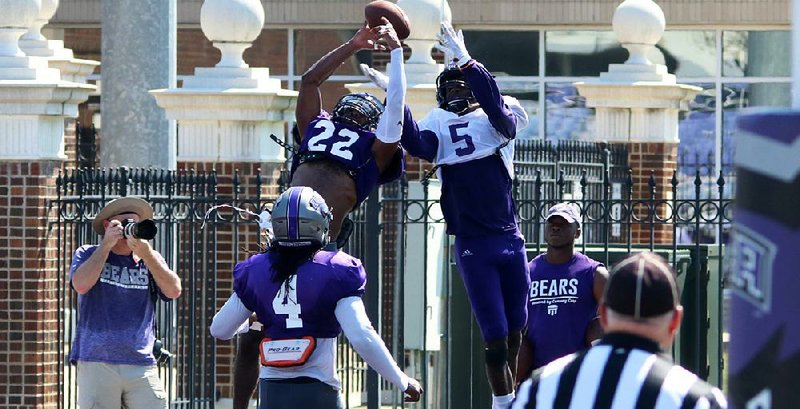 UCA defensive back Duke Upshaw (22) breaks up a pass intended for wide receiver Lujuan Winningham during Saturday’s scrimmage at Bear Stadium in Conway.