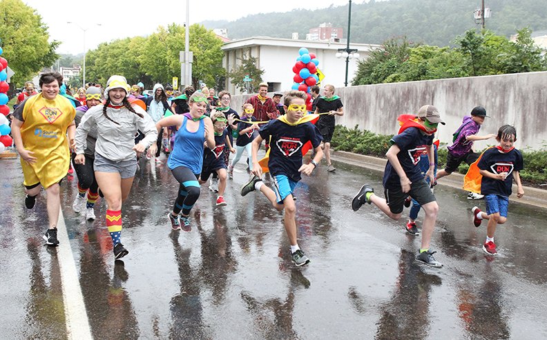 Participants in the inaugural Tri-Lakes CASA/Spa-Con Superhero Fun Run take off from the start on Convention Boulevard on Saturday, Sept. 23, 2018.