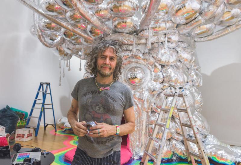 What started as a "freak-out experience" that could be enjoyed during one of the Flaming Lips' drug-fueled, late-night parties in their hometown of Oklahoma City has expanded to encompass a whole world. Lead singer Wayne Coyne's immersive art installation "King's Mouth" went through several iterations to become what it is today. The head -- which invites viewers to crawl inside to experience a psychedelic and surreal light show that engulfs the senses -- was the first piece. From there, a series of drawings and collages prompted by the installation led Coyne to establish a fantasy narrative around the King's birth, life and eventual death. The Lips couldn't have such an intriguing story line and not put it to music, so the album came next. "King's Mouth: Album and Songs" serves as an aural companion piece to the installation, with the tunes adding more dimension to the world surrounding the giant metallic head.