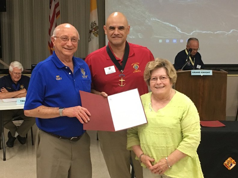 Submitted photo FAMILY OF THE MONTH: Members of the Knights of Columbus Daniel P. Sullivan Council 10208 of Hot Springs Village received awards from Grand Knight Rich Rivera during the August council meeting. Mike, left, and Chris Franz were the Family of the Month for July 2019. Mike Franz helps with the Blind Camp transportation and bowling, and works with the Animal Welfare League. Chris Franz coordinates the funeral ministry, participates in Helping Hands and Sunshine Cards, and participates in Good Sam's Bingo, Meals on Wheels, Animal Welfare League, Adoption Center Worker and fundraisers.