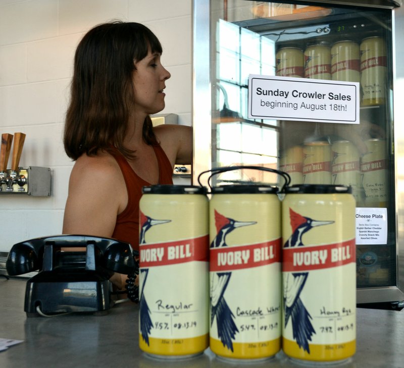 Sierra Bush/Siloam Sunday Dorothy Letellier, co-owner of Ivory Bill Brewing, organizes crowlers in preparation for an ordinance to go into effect on Sunday, Aug. 18, that allows any Siloam Springs small brewery, nano brewery and microbrewery restaurants operating in accordance with state law to sell beer, malt beverages and hard cider for off-premise consumption on Sundays. According to the amendment to the city's code, anyone found violating it will be subject to a fine from $50 to $100.