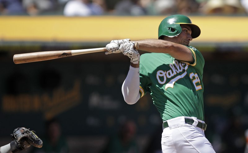 Oakland Athletics' Matt Olson swings for an RBI-single off Houston Astros' Rogelio Armenteros in the third inning of a baseball game Saturday, Aug. 17, 2019, in Oakland, Calif. (AP Photo/Ben Margot)