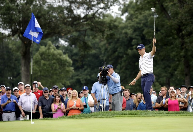 The Associated Press SETTING THE BAR HIGH: Justin Thomas celebrates as he makes a birdie on the 14th hole Saturday during the third round of the BMW Championship at Medinah Country Club in Medinah, Ill.