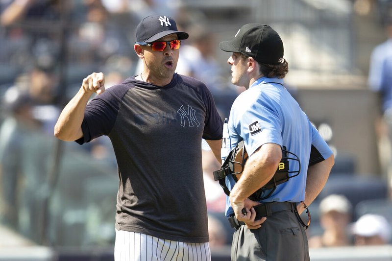 The Associated Press
HEATED ARGUMENT:
New York Yankees manager Aaron Boone, right, argues with home plate umpire Ben May after being ejected during the sixth inning of Saturday's game in New York.