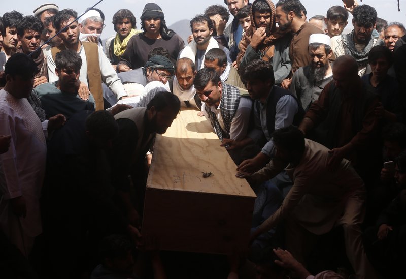 Afghans carry the body of a victim of the Dubai City wedding hall bombing during a mass funeral Sunday in Kabul, Afghanistan. (AP Photo/Rafiq Maqbool)