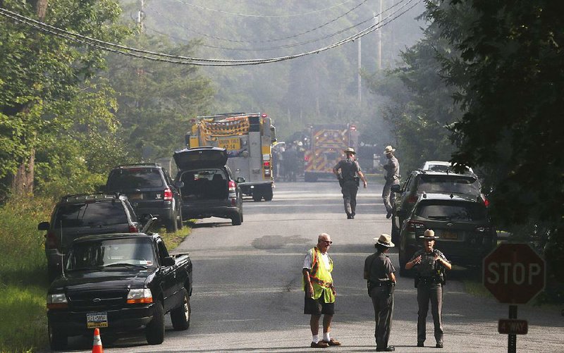 Police close off a road Saturday as rescue workers respond to the plane crash in Union Vale, N.Y. 