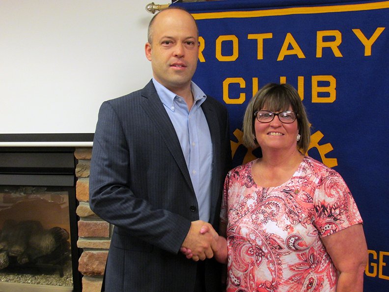 Submitted photo ROTARY GUEST: Hot Springs Village Area Chamber of Commerce Executive Director Nathan Hunnicutt, left, is greeted by HSV Rotary President-elect Susan Clark.