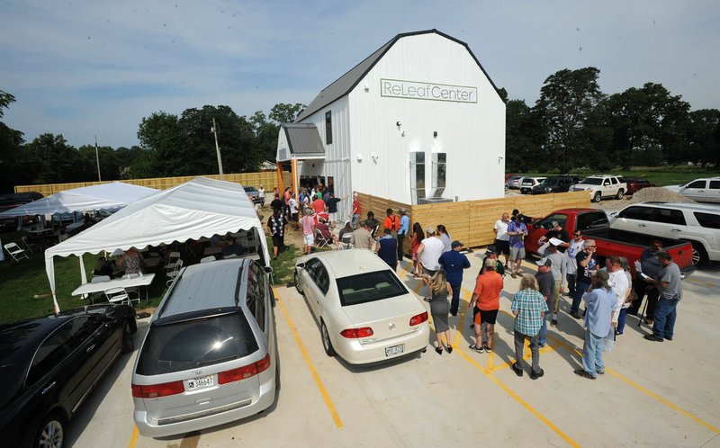 File Photo/NWA Democrat-Gazette/ANDY SHUPE A long line forms Aug. 7 during the opening for The ReLeaf Center, a medical marijuana dispensary at 9400 E. McNelly Road in Bentonville, the first dispensary to open in Northwest Arkansas.