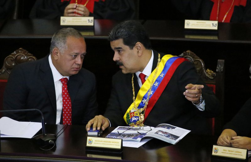 FILE - In this Jan. 24, 2019 file photo, Venezuelan President Nicolas Maduro, right, speaks with Constitutional Assembly President Diosdado Cabello at the Supreme Court during an annual ceremony that marks the start of the judicial year in Caracas, Venezuela. The U.S. has opened up secret communications with Cabello as members of Maduro’s inner circle seek guarantees they won’t face retribution if they cede to growing demands to remove him, a senior administration official told The Associated Press on Saturday, Aug. 17, 2019. (AP Photo/Ariana Cubillos, File)

