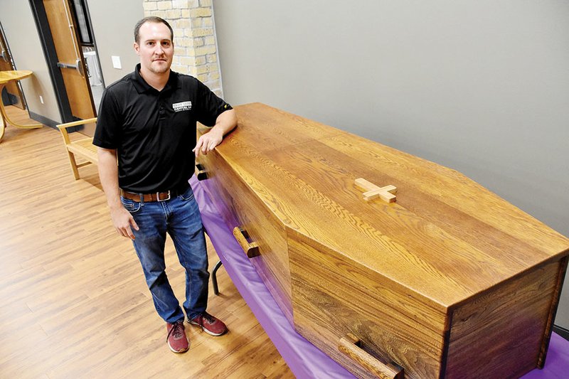 Lucas Strack of Conway stands with the coffin he made for the St. Joseph School Bazaar in August. Strack, an architect and owner of Strack Studio Furniture, got the blueprints from the Benedictine monks at Subiaco Abbey. The coffin is for sale and can be seen at the St. Joseph School Endowment Office, 1315 College Ave. in Conway.
