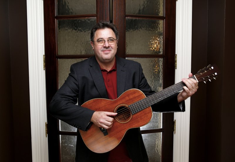 FILE - In this Feb. 1, 2016 file photo, Vince Gill poses for a photo at his home in Nashville, Tenn. Gill doesn't hold back on weighty topics of regret, faith, his marriage and sexual abuse on his new record "Okie" coming out on Aug. 23, 2019. The Grammy-winner admitted to breaking down in the studio as he sang a song for his wife, Amy Grant, but he said there's a lot of emotion tied up his songs, some of which he waited a lifetime to write and record. (Photo by Donn Jones/Invision/AP, file)