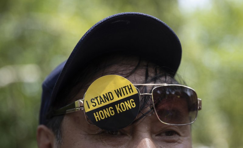 A man with a sticker that reads &quot;I Stand With Hong Kong&quot; on his glasses gathered with others in Lafayette Square in front of the White House in Washington, Sunday, Aug. 18, 2019, in solidarity with the &quot;Stand With Hong Kong, Power to the People Rally&quot; in Hong Kong. (AP Photo/Carolyn Kaster)